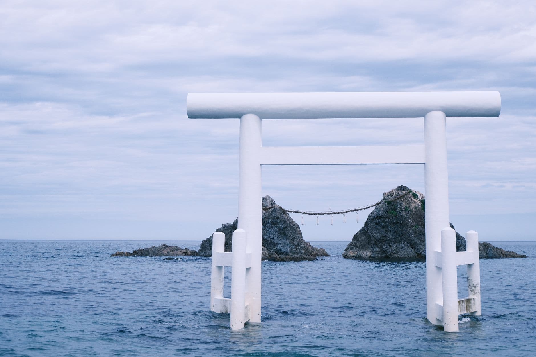 Peaceful ocean scene featuring a torii gate at Itoshima, Japan. Ideal for travel and cultural themes.